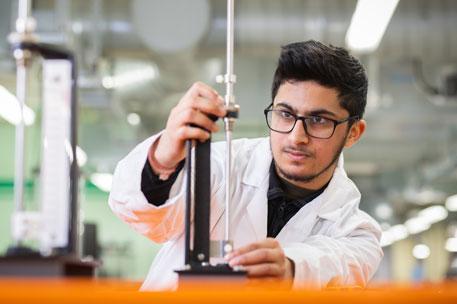 A civil and structural engineering student working in a lab.