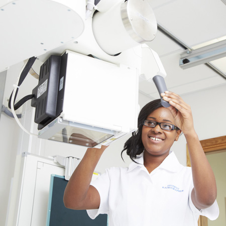 A student optometrist using specialist equipment