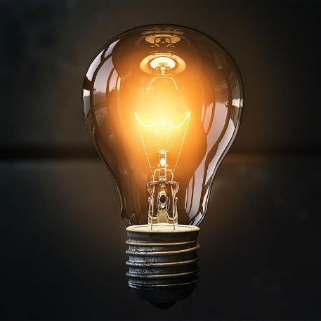 Photo of a lit lightbulb against a dark background
