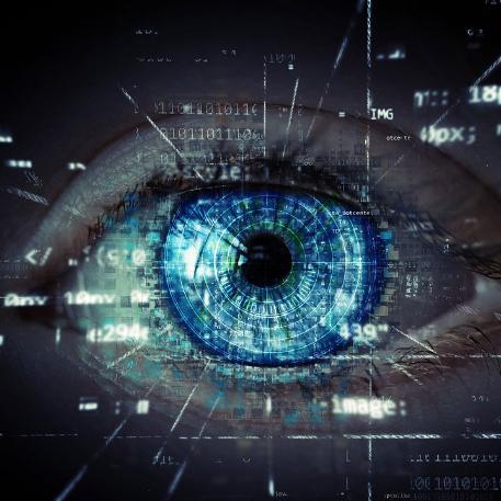 Photo of a blue eye with digital text in the foreground representing humane technology