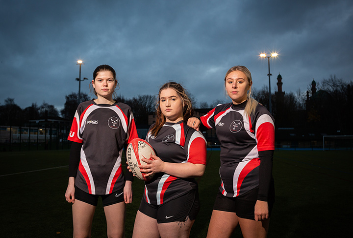 Three rugby team members in University of Bradford kit