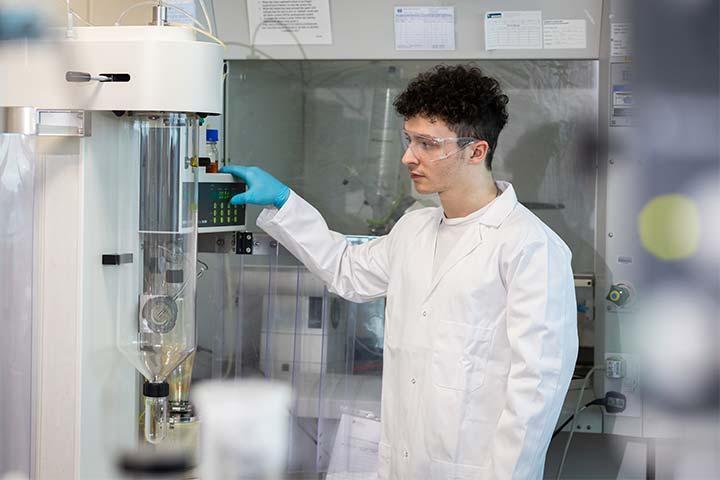 A student in a lab using industry-standard equipment.