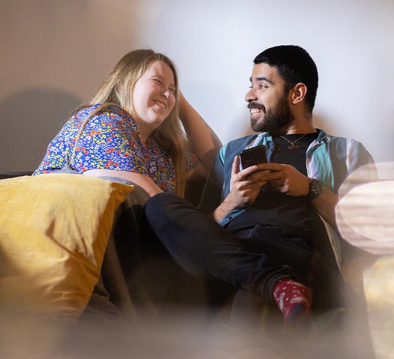 Two students chatting and laughing.