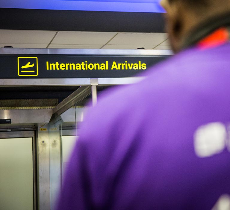 A student ambassador waiting at the international arrives.