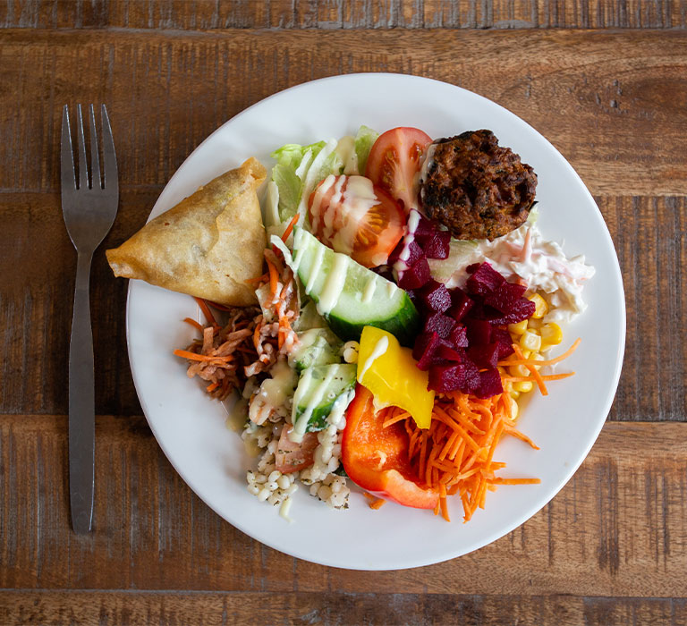 A plate of food on a wooden table.