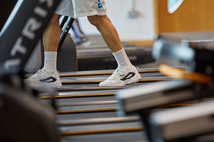 Gym members legs on a treadmill
