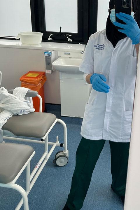 Zaynab in uniform in a ward.