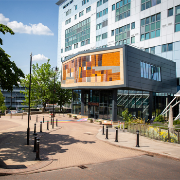 A bright and sunny view of the front of Richmond Building on the University of Bradford campus.