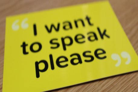 A yellow 'I want to speak please' sign. Grid box size.