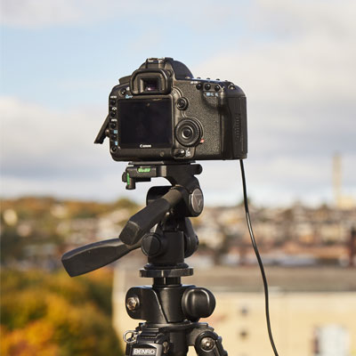 A DSLR camera on a tripod.