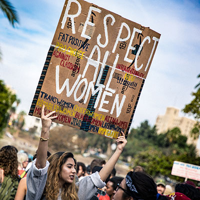 A female protestor holding up a placard.