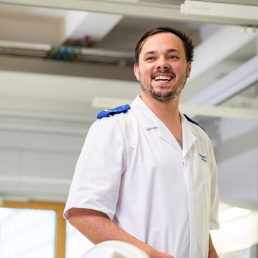 A smiling student wearing nursing uniform.