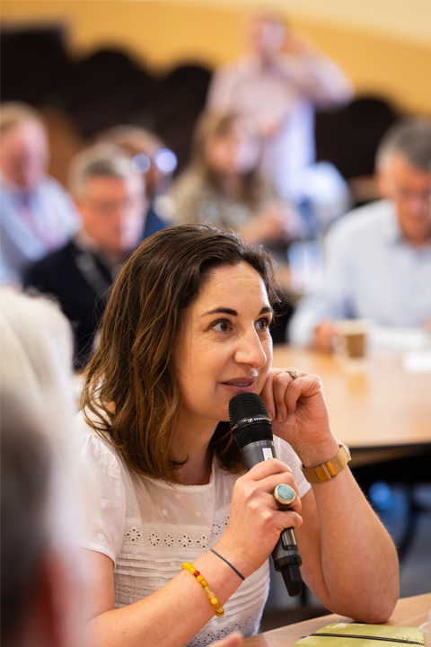 An MBA Summit 2024 attendee asking a question during a Q and A session