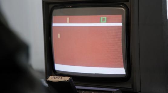 A 1980s video game is played on a TV screen