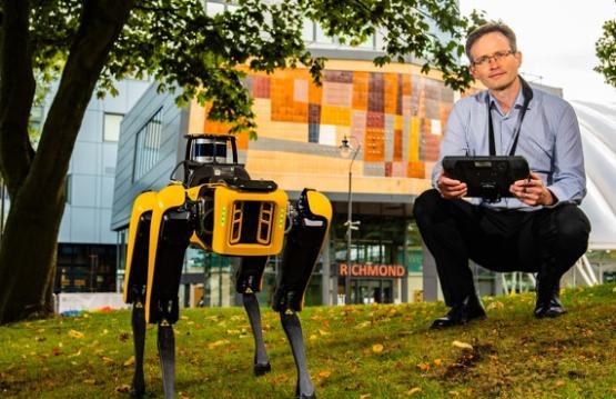 Professor Andrew Wilson with a robot dog