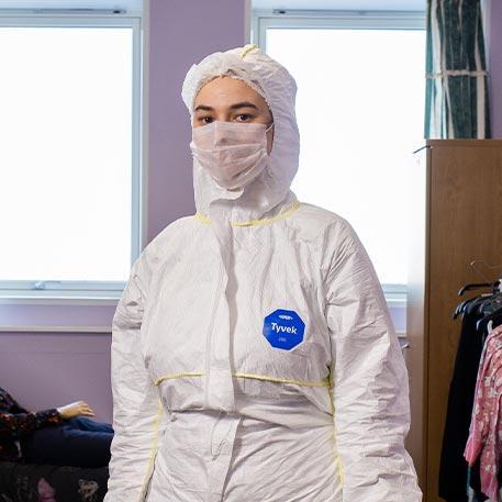 A student in PPE in a simulated crime scene.