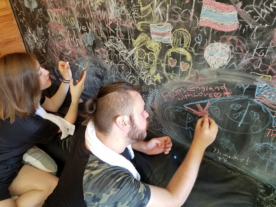 University of Bradford student Xander writing on a chalk board